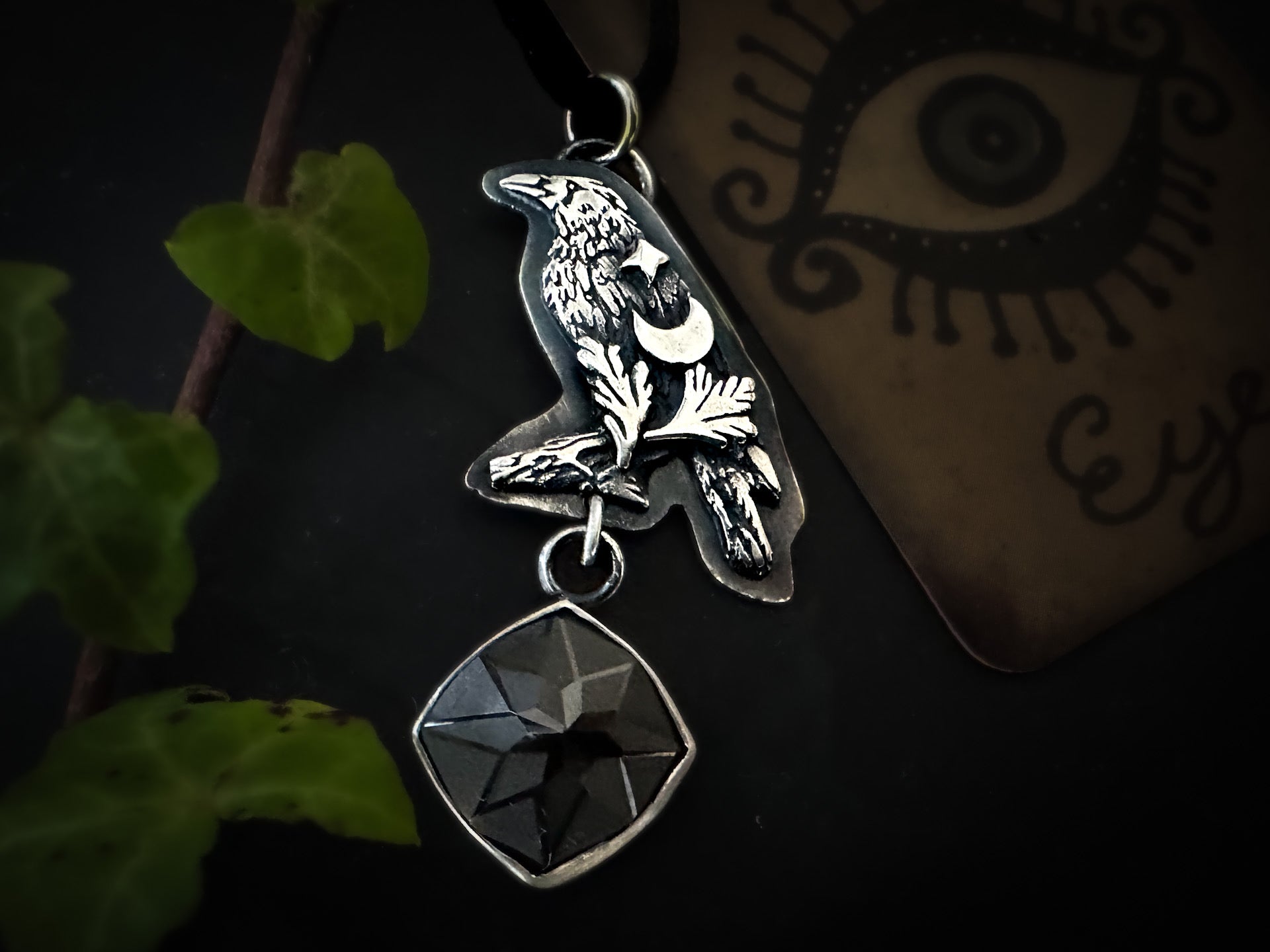 Engraved black, hexagon spinel crow pendant in sterling silver, part of the Little Familiars Collection by Silver Labyrinth Jewelry 