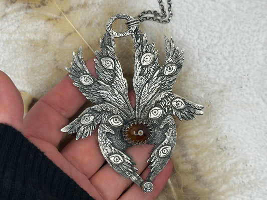 Handmade Sterling Silver Biblically Accurate Angel Pendant with Eye Agate and Salt and Pepper Diamond. Unique occult jewellery 
This detailed sterling silver pendant features eight wings, intricate eyes, and feathers. Designed and handmade by Jen Smith, it includes a chain and is available in other sizes.