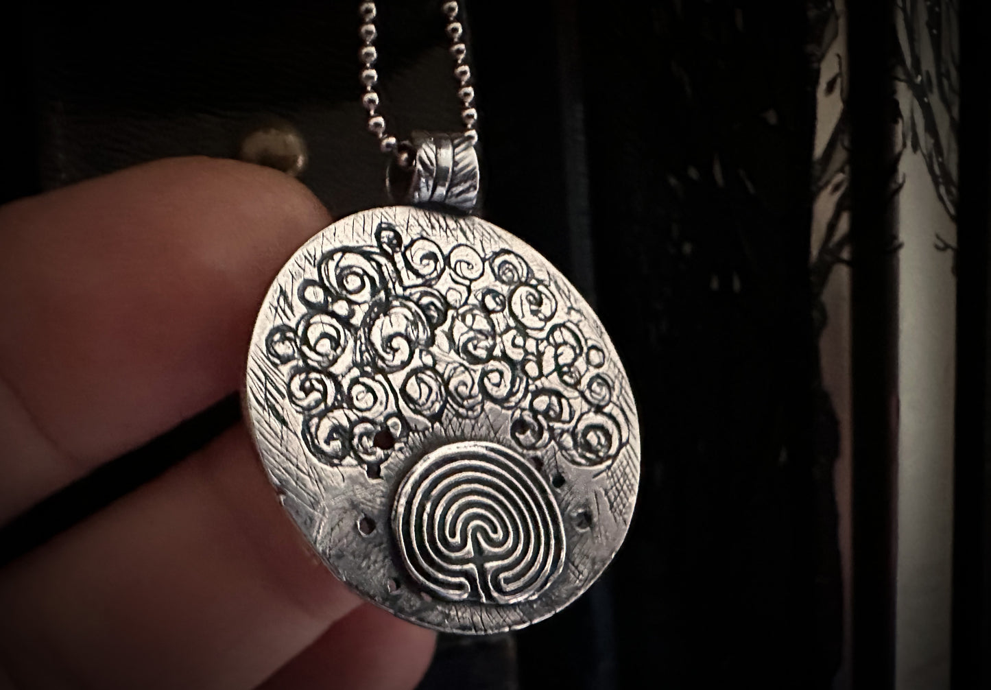 Detailed back view of Raven pendant. Handmade in silver.