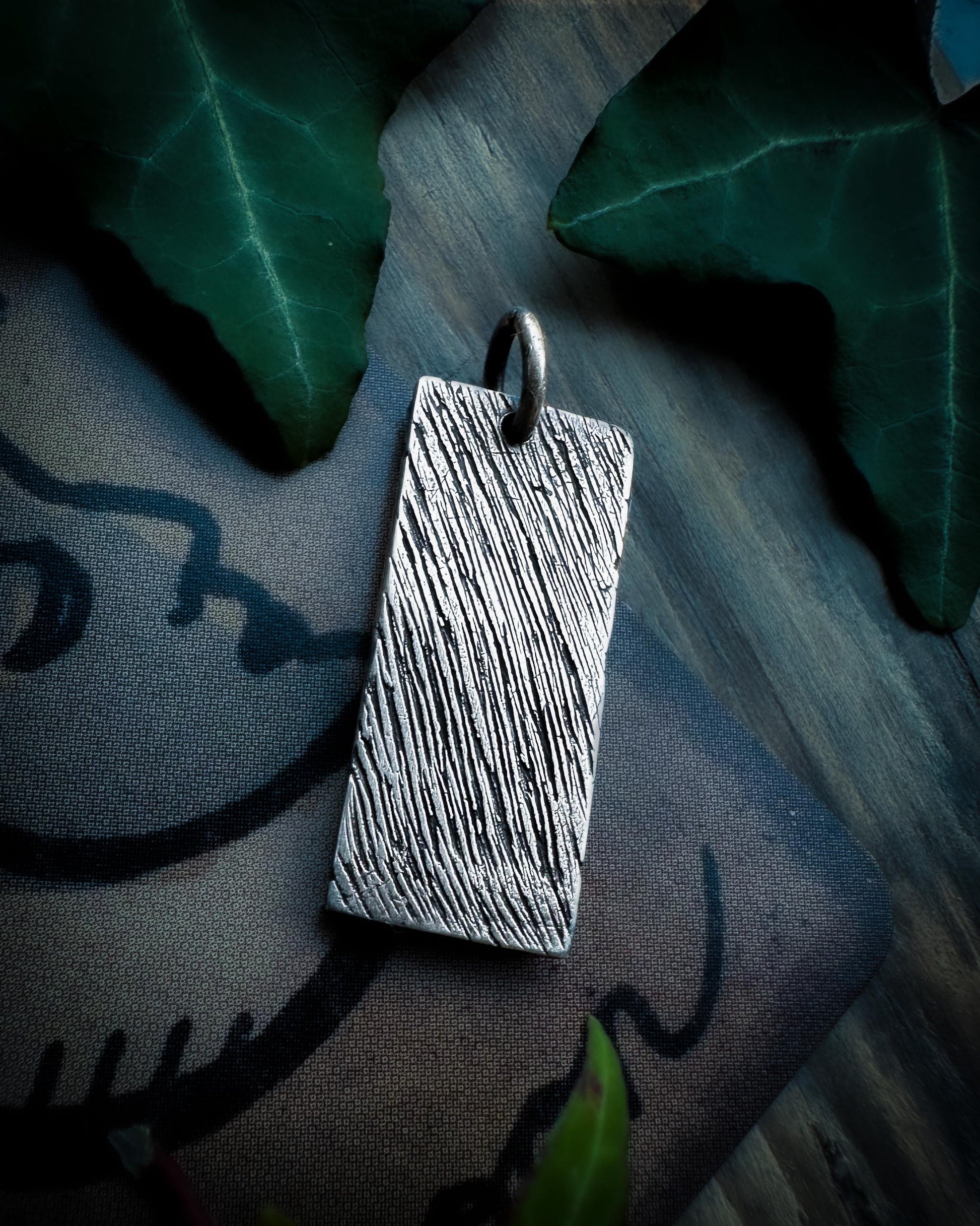 Back view f sterling silver, handmade hare pendant. By Silver Labyrinth Jewelry.