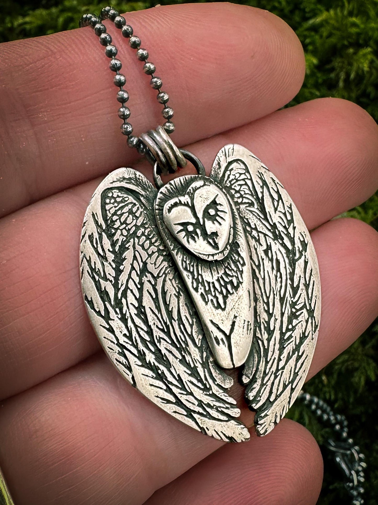 Hand-finished silver Barn Owl pendant showcasing intricate craftsmanship and a high-polish patina finish.