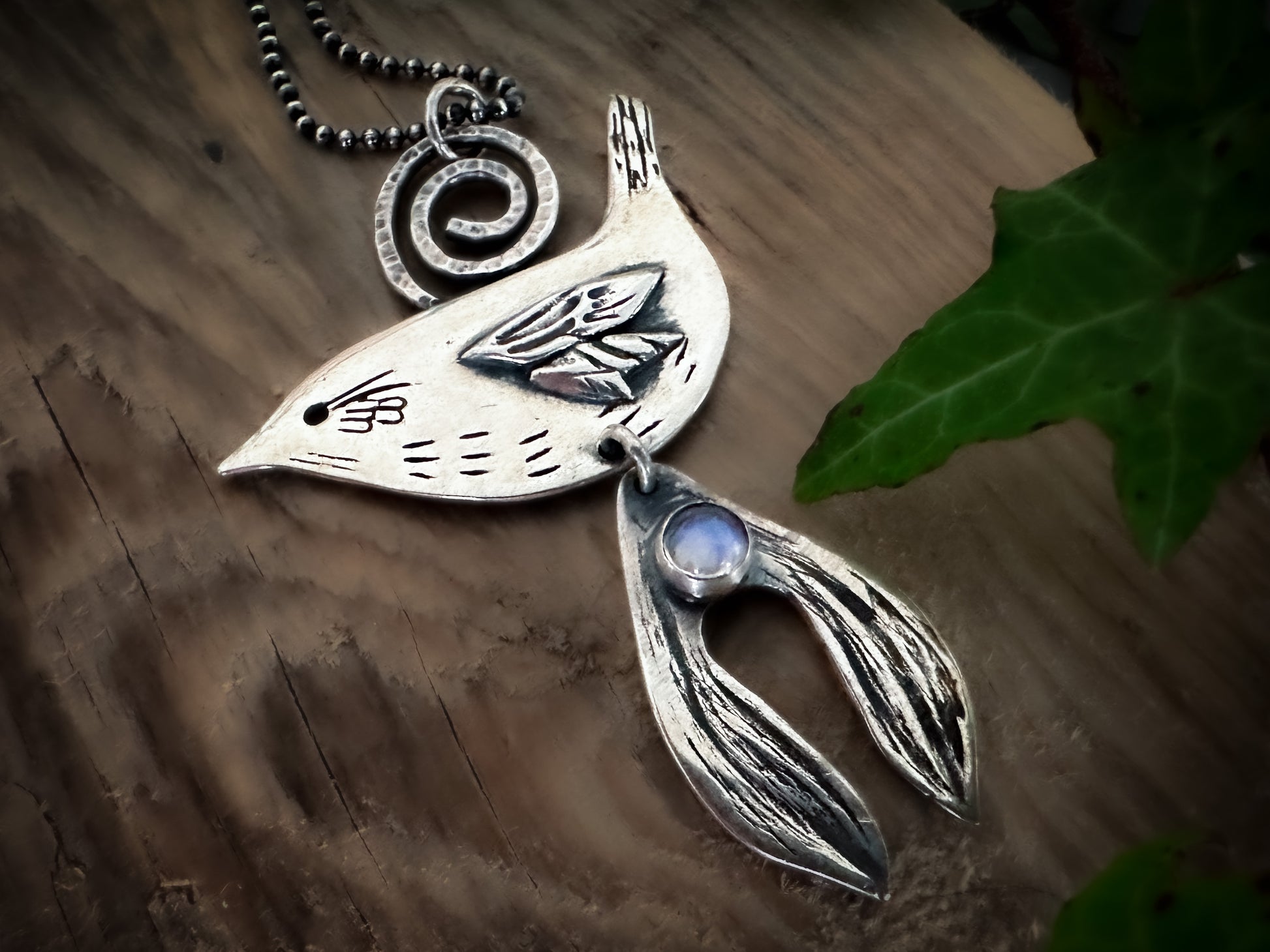 Druid Bird with Mistletoe pendant. Inspired for Yule. A side profile wren with a hammered spirel bail, mistletoe and rainbow moonstone cabochon. All finely detailed. By Silver Labyrinth Jewelry