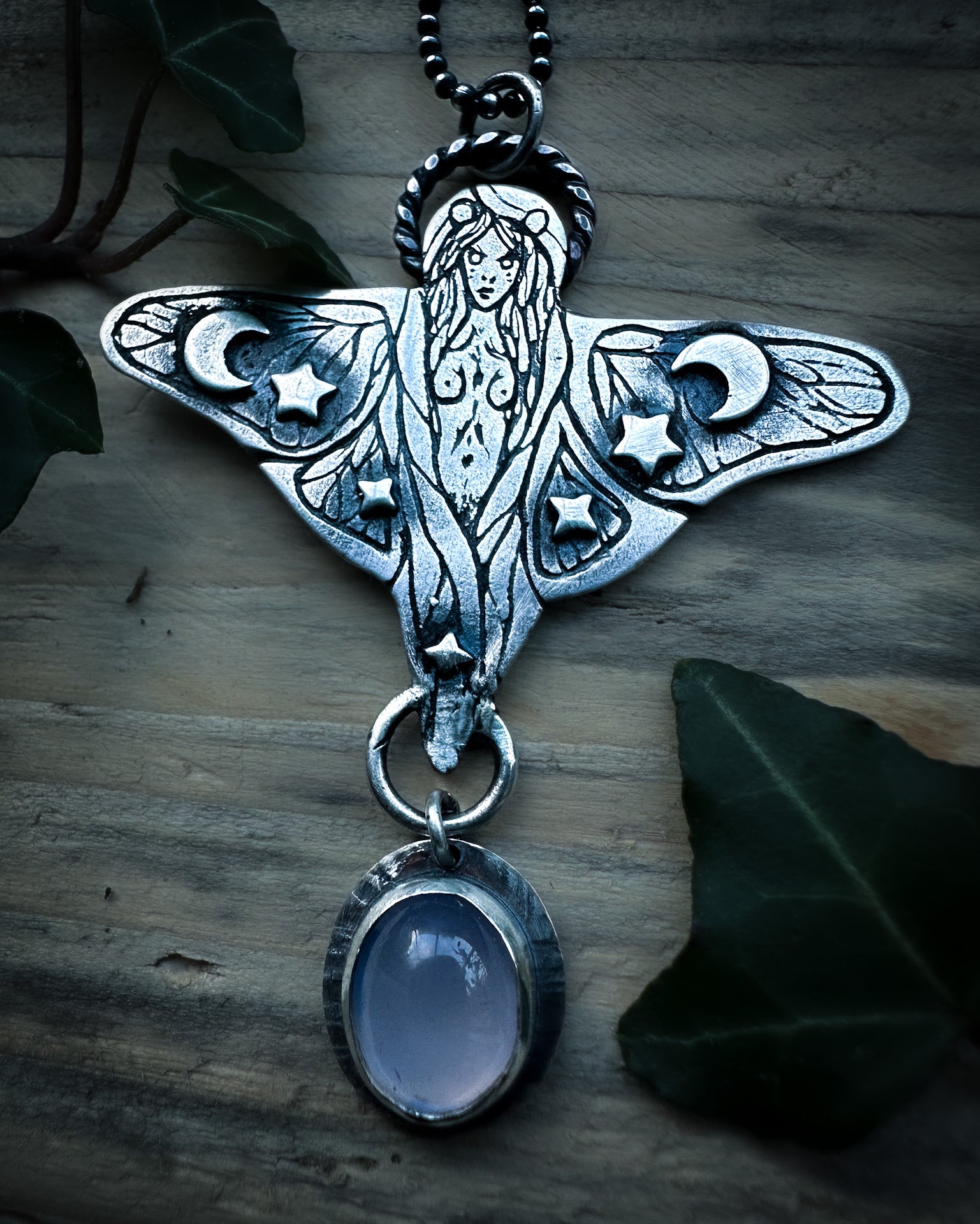 Celestial faerie pendant featuring stars, moons and intricate details