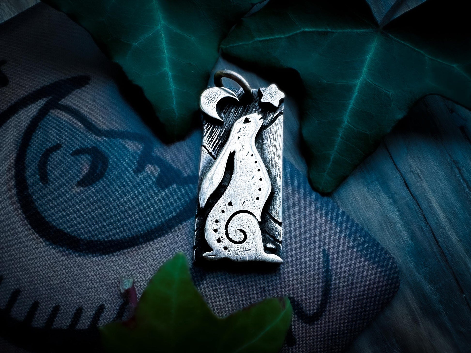 Front view, a hare gazing up at night. With a star and crescent moon. Handmade in sterling Silver. Silver Labyrinth Jewelry.