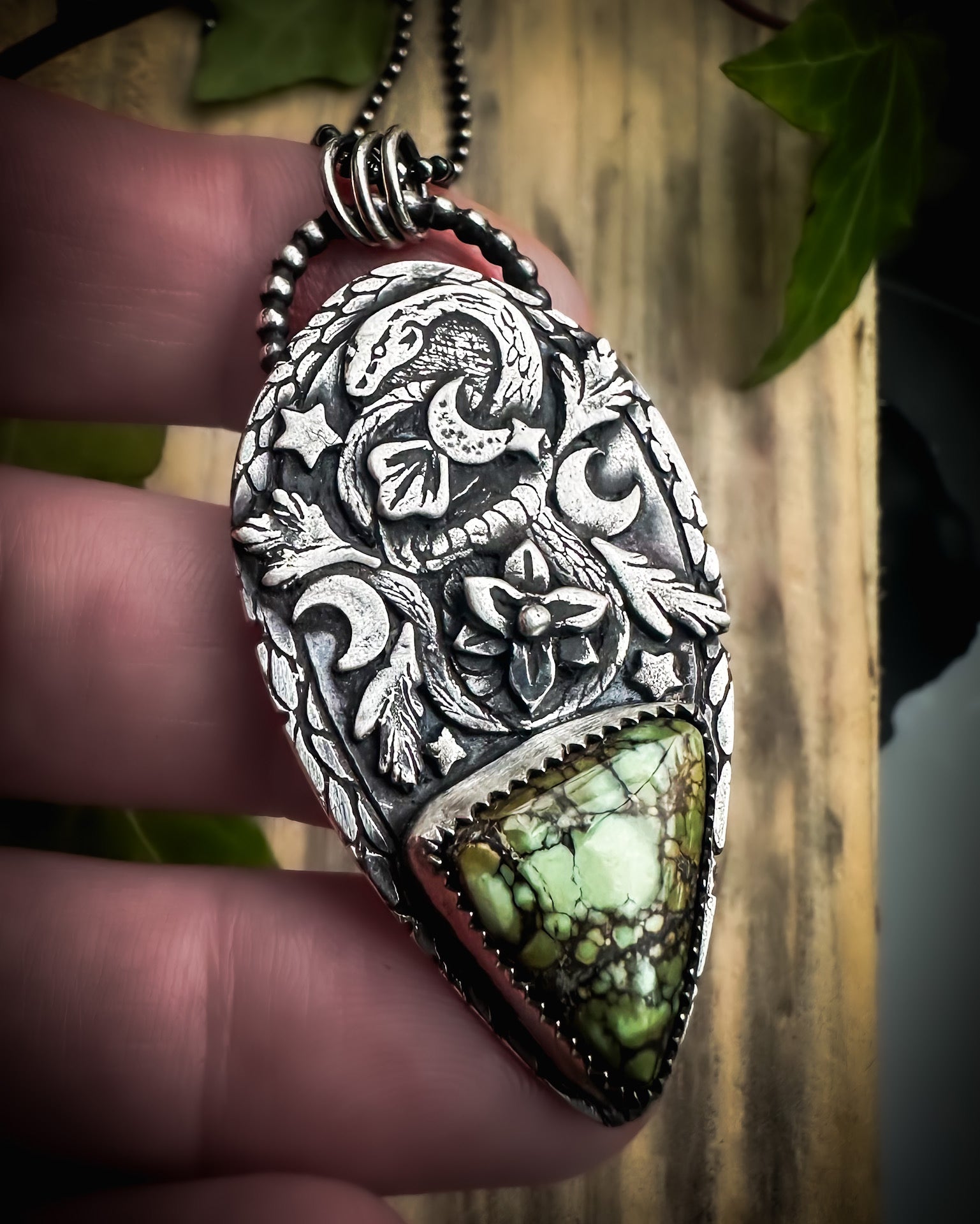 Sterling silver snake totem pendant with a coiled design, leafy accents and a rare variscite stone