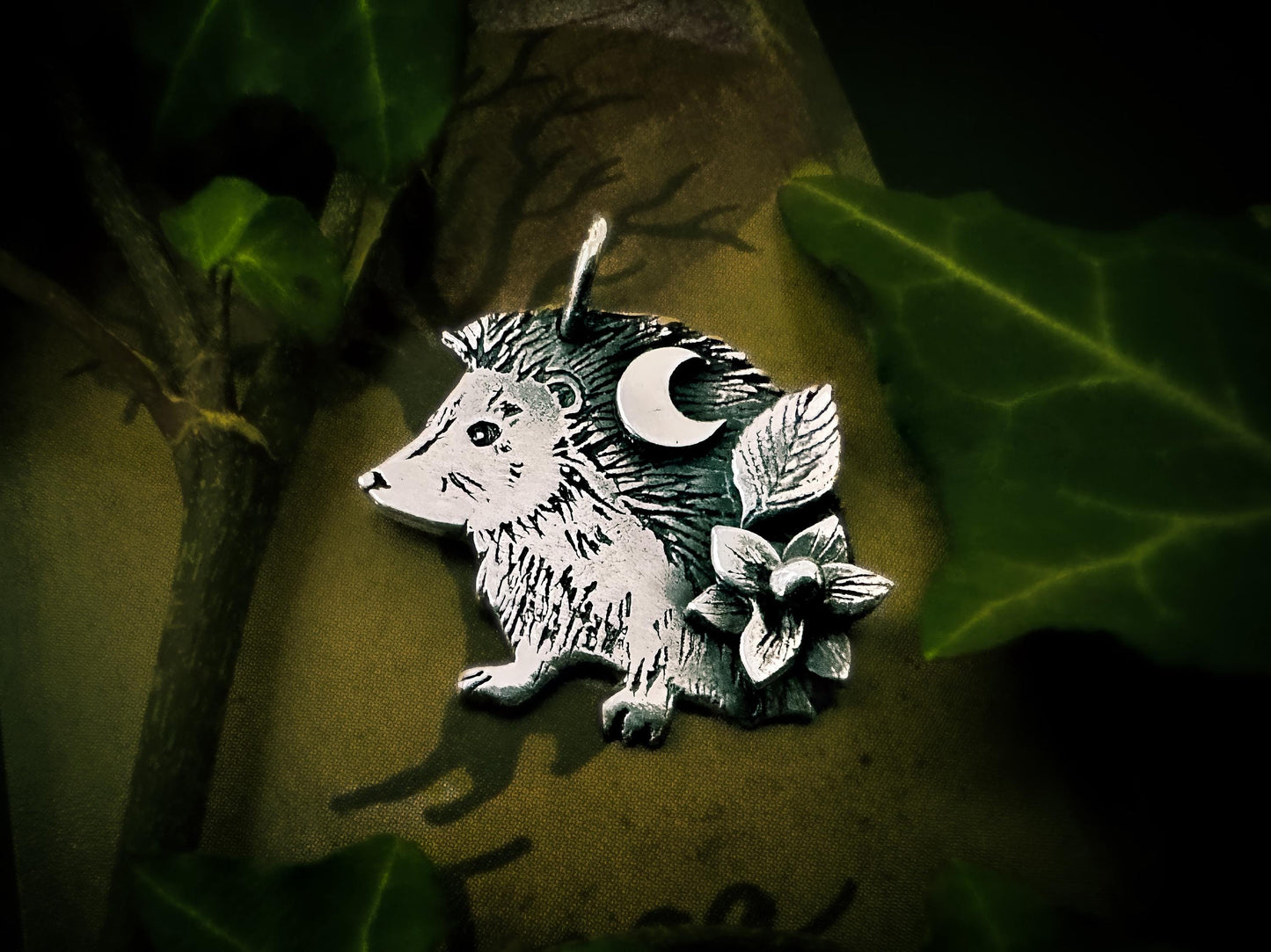 Dainty hedgehog pendant charm, with crescent moon, leaf and flower. Handmade in sterling silver by Jen Smith of Silver Labyrinth Jewelry