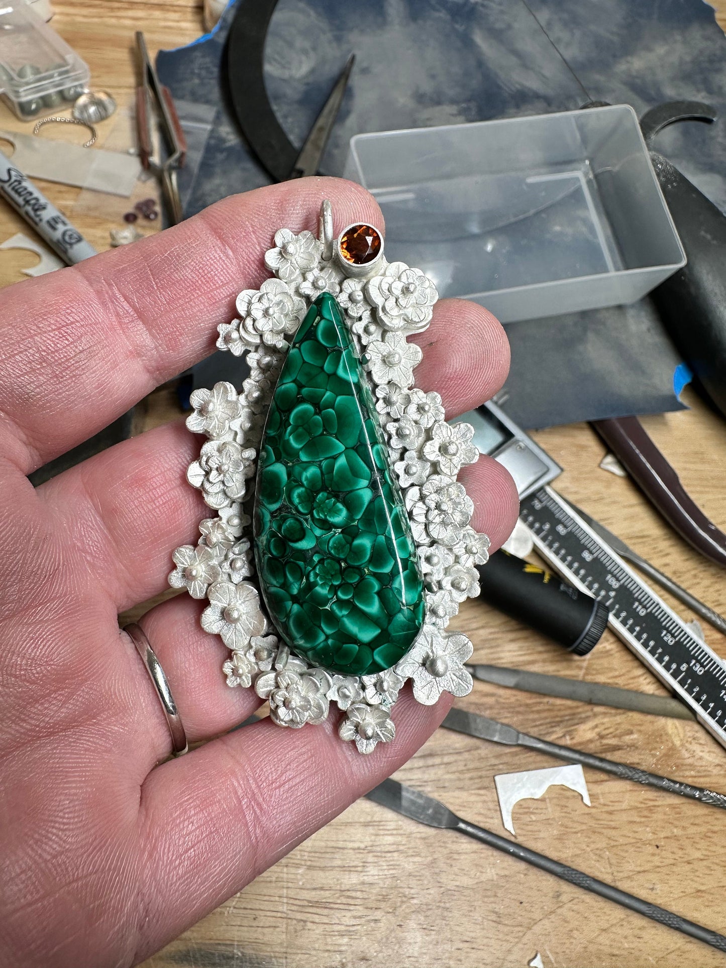 Picture of the making of the stunning malachite pendant in the studio. By Silver Labyrinth Jewelry