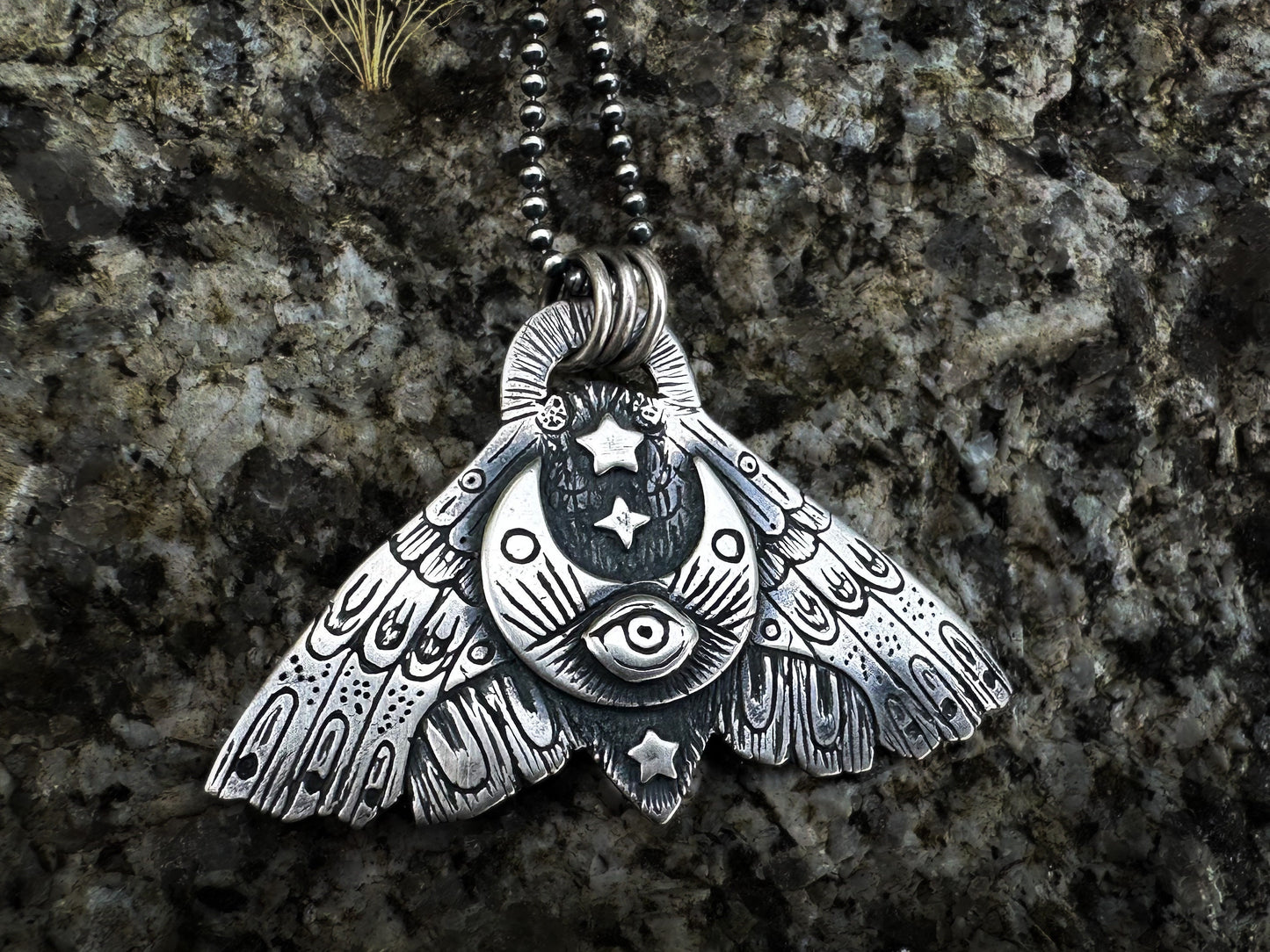 Detailed sterling silver Moth pendant with a sickle moon and symbolic motifs for self-discovery