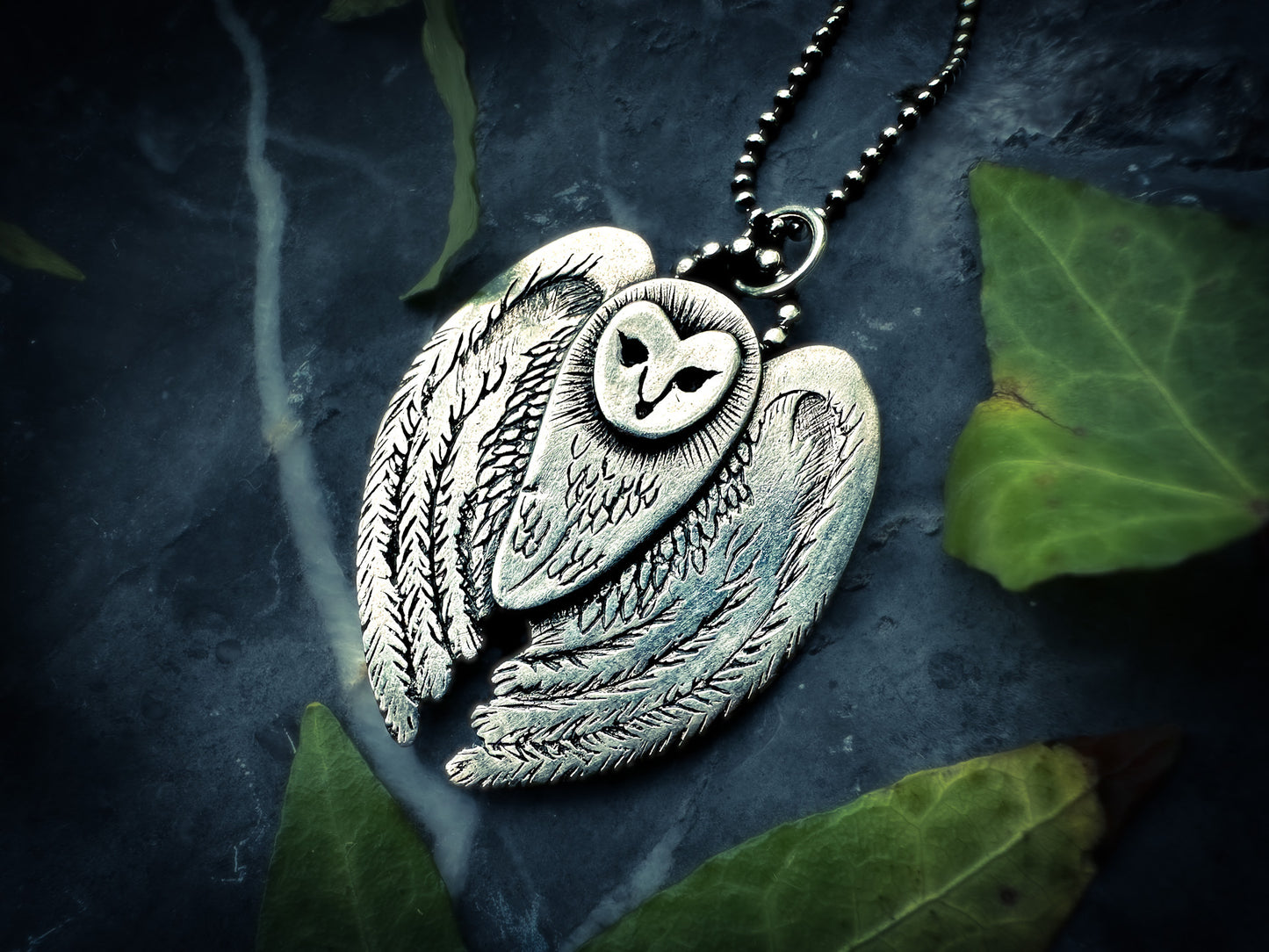 Stylized Barn Owl pendant in sterling silver, hanging from an 18” chain