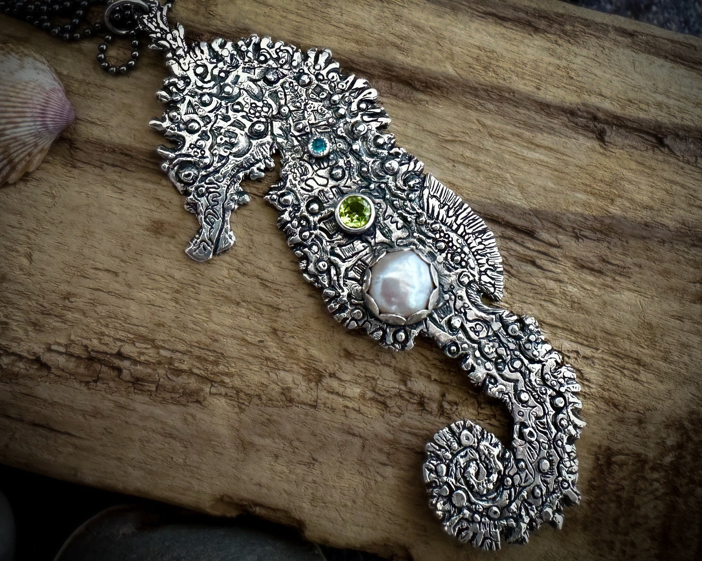 Sterling silver seahorse necklace with pearl, peridot, and neon apatite, capturing coral reef hues