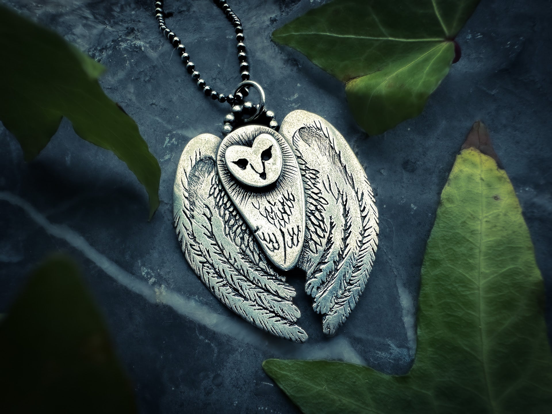 Detailed owl pendant with textured back and polished silver finish