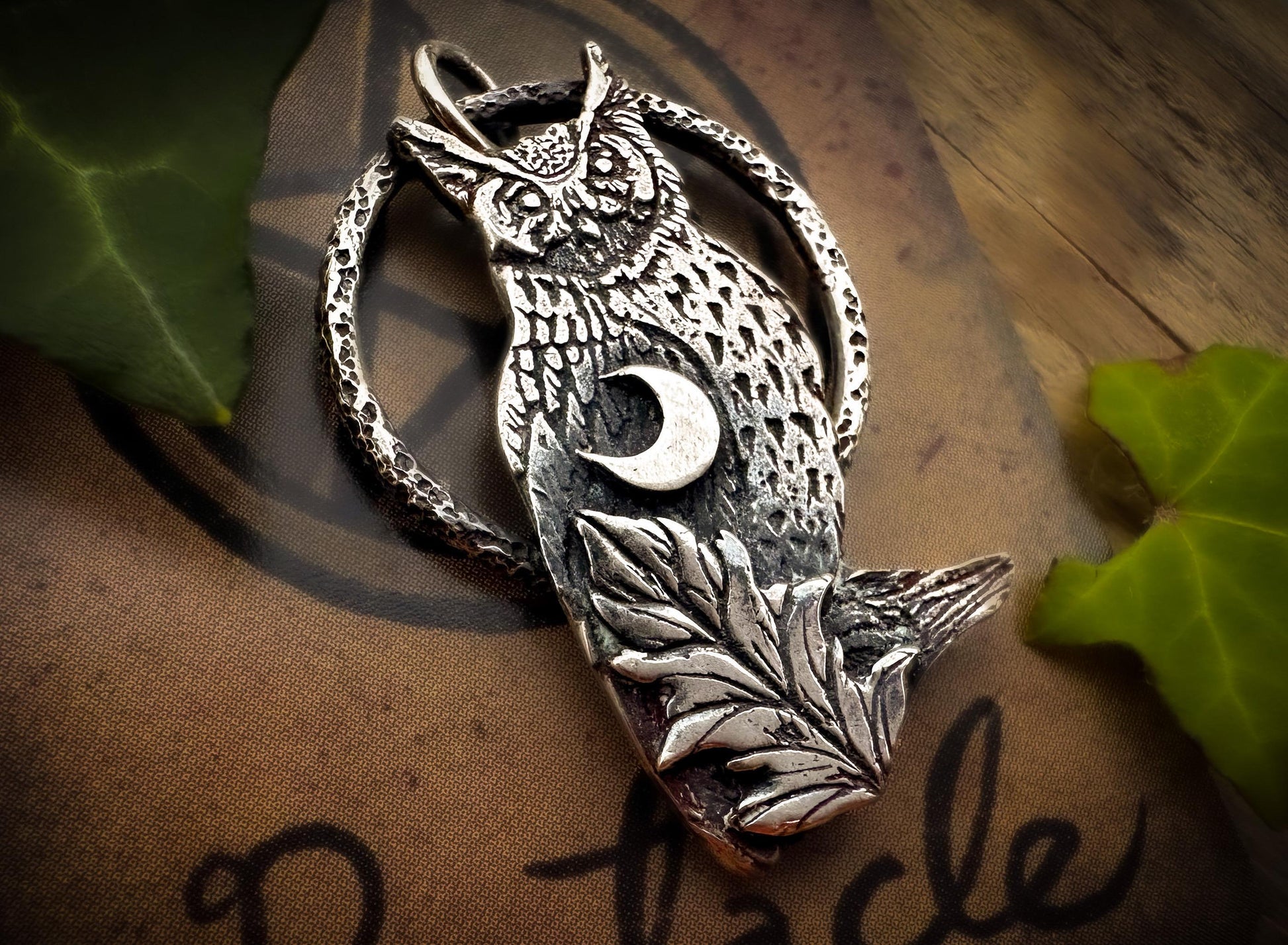 Sterling silver owl pendant with a leaf and a crescent moon from Silver Labyrinth Jewelry. 