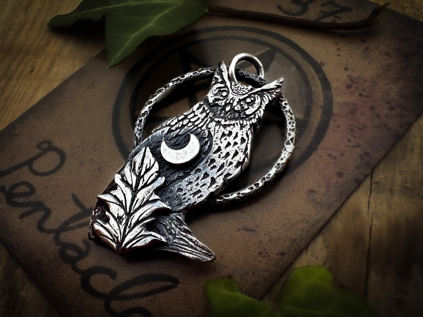 Owl in sterling silver with a crescent moon and a leaf. Finely detailed, designed and handmade by Jen Smith