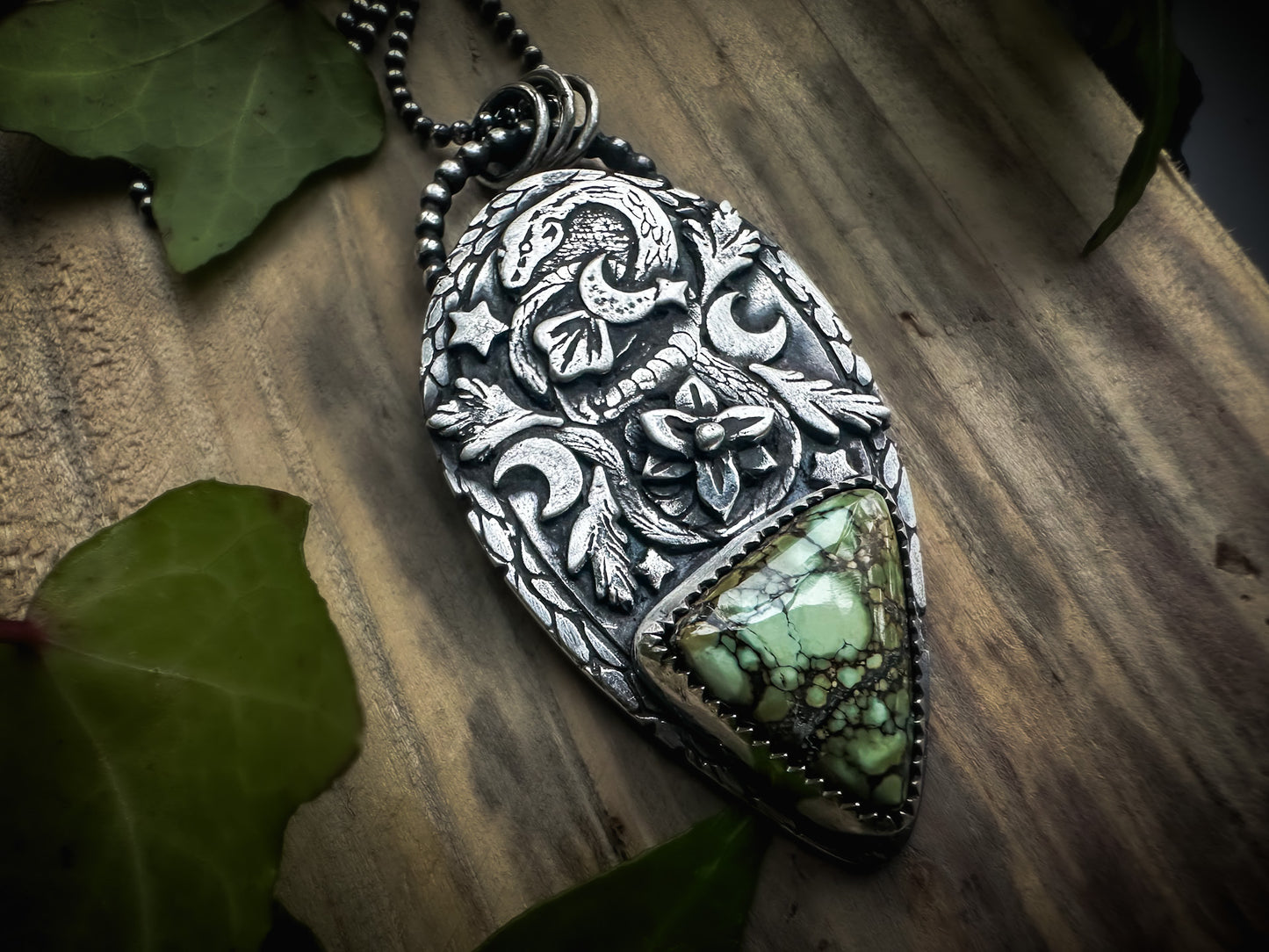 Handmade sterling silver pendant with a coiled snake, rare Damele variscite, and intricate nature-inspired details. By Silver Labyrinth Jewelry