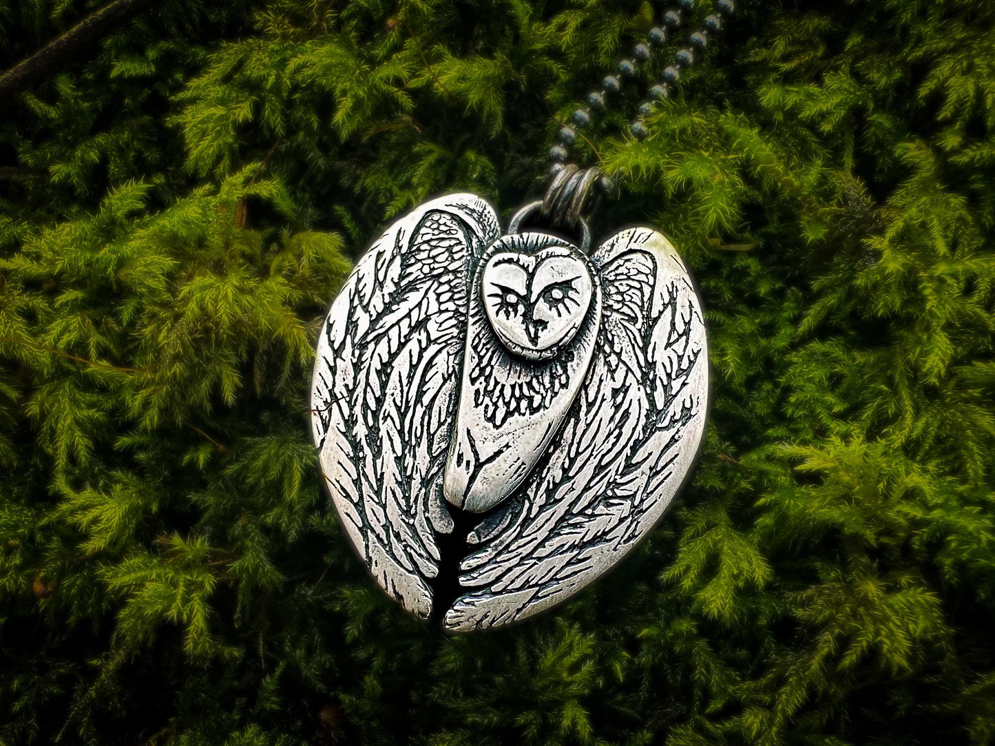 Hand-finished silver Barn Owl pendant showcasing intricate craftsmanship and a high-polish patina finish.