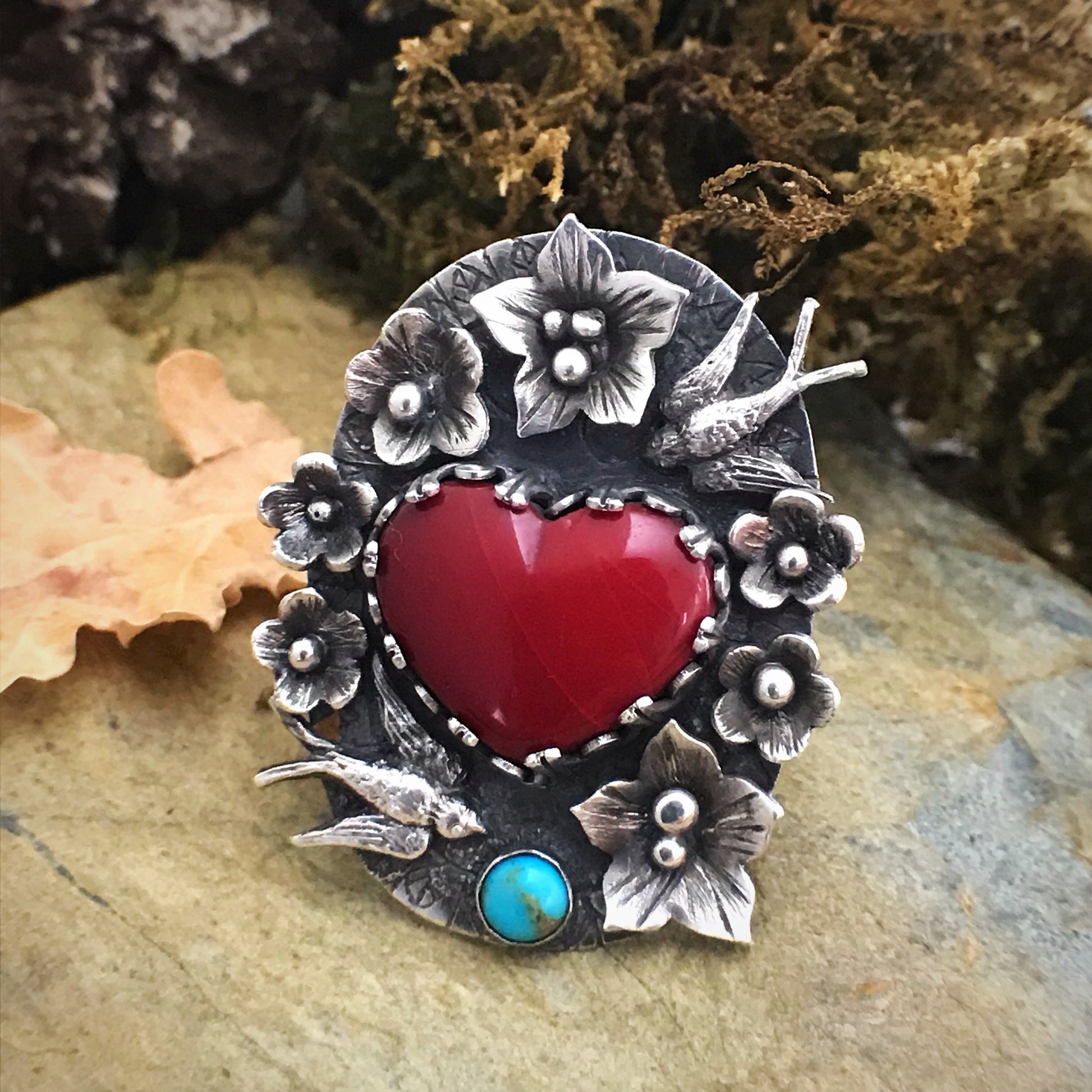 A tattoo inspired rosarita heart cabochon ring with birds, flowers and turquoise. Exquisite detail enhanced by patina. By Silver Labyrinth Jewelry