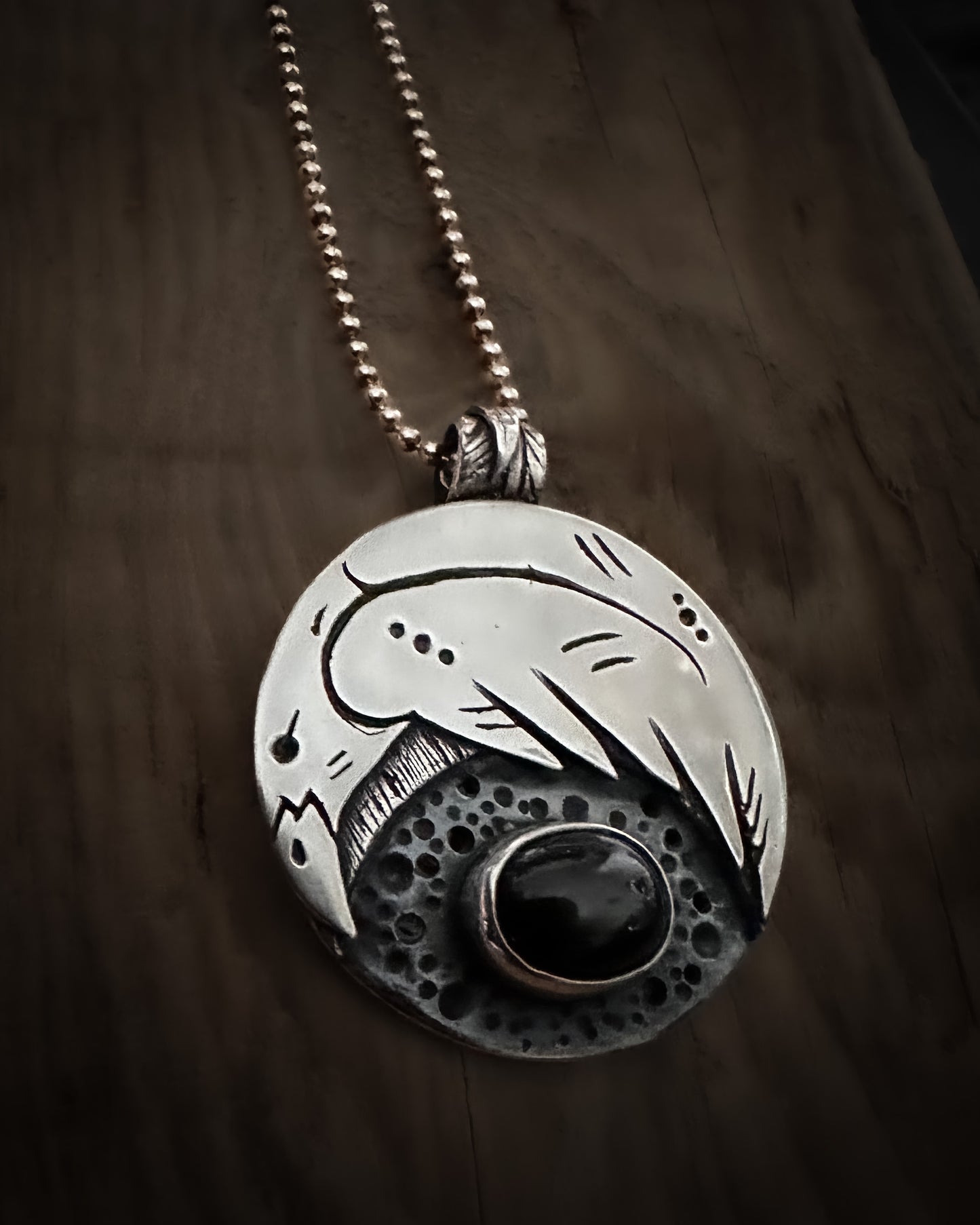 Handmade sterling silver Raven talisman, with a bezel set black star diopside. Viking inspired jewellery.