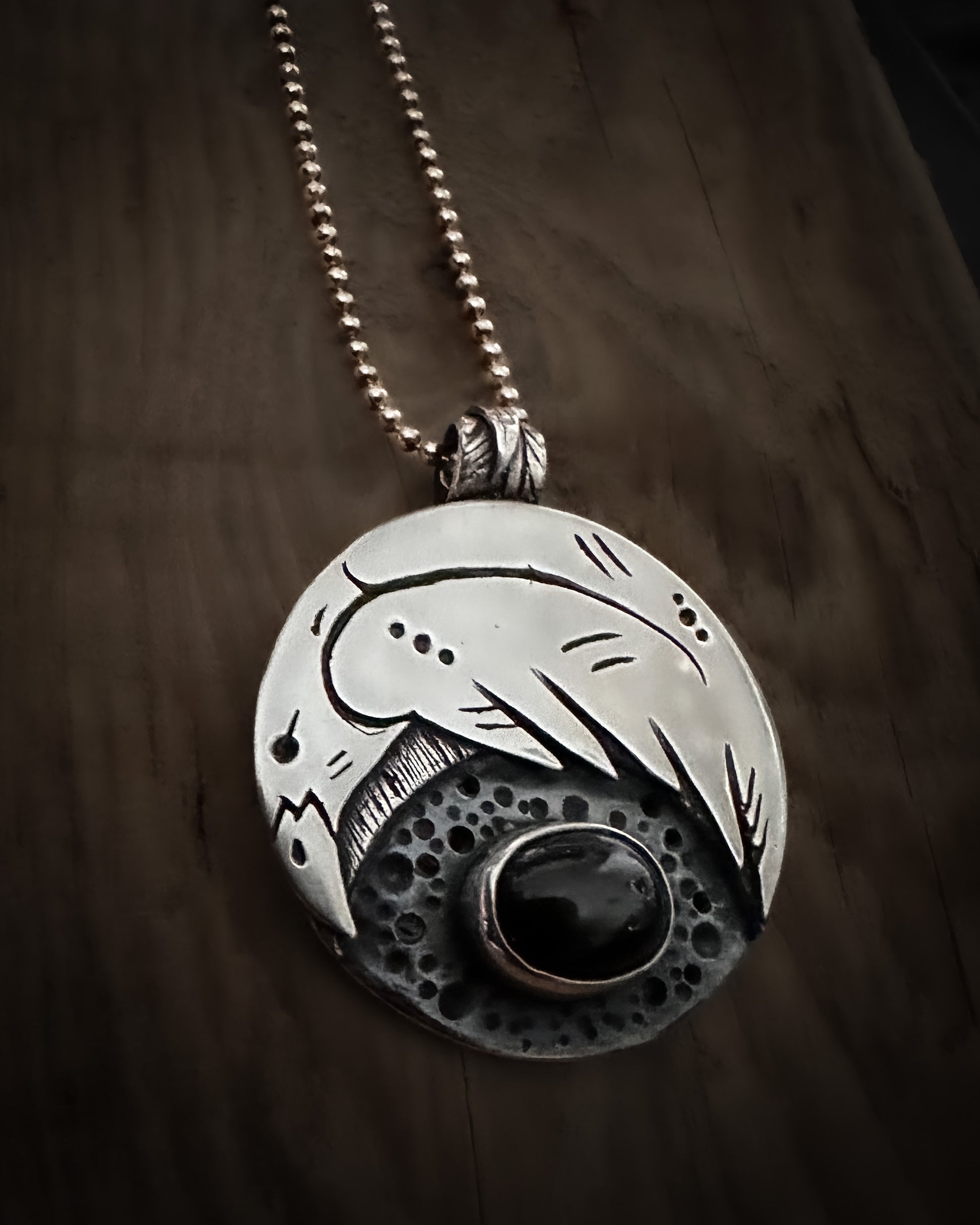 Handmade sterling silver Raven talisman, with a bezel set black star diopside. Viking inspired jewellery.