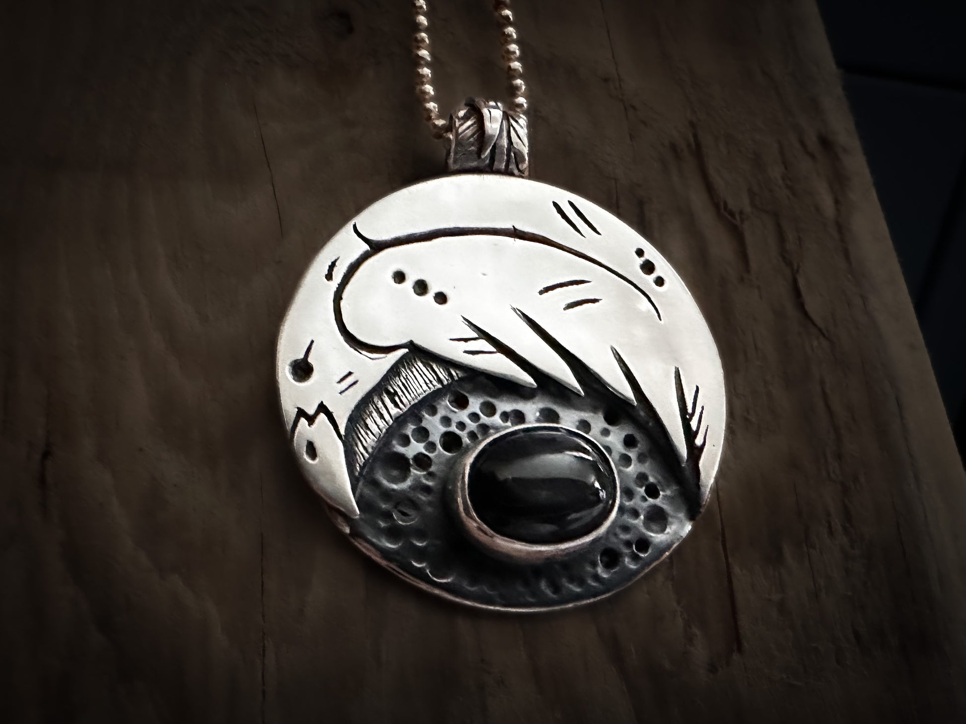 Handmade sterling silver raven pendant with Norse-inspired details and black star diopside. Handmade by Silver Labyrinth Jewelry 